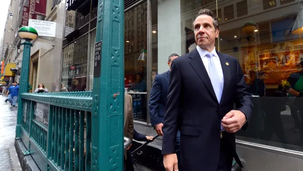 Former New York Governor Andrew Cuomo walking down city street.