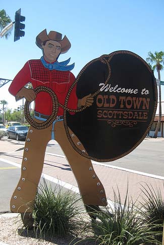 Photo: a cowboy cutout lassos a sign that reads Welcome to Old Town Scottsdale.