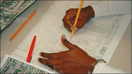 Hands drawing plans.