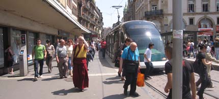 Photo: Lots of pedestrians and a tram sharing space.