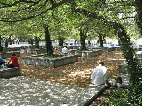 people sitting along tree boxes in chicago art institute's south garden