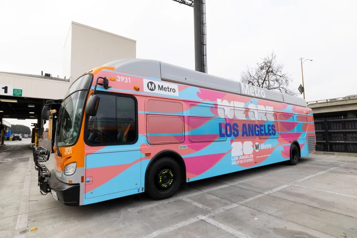 An LA Metro bus with pink wrap that celebrates the FIFA World Cup