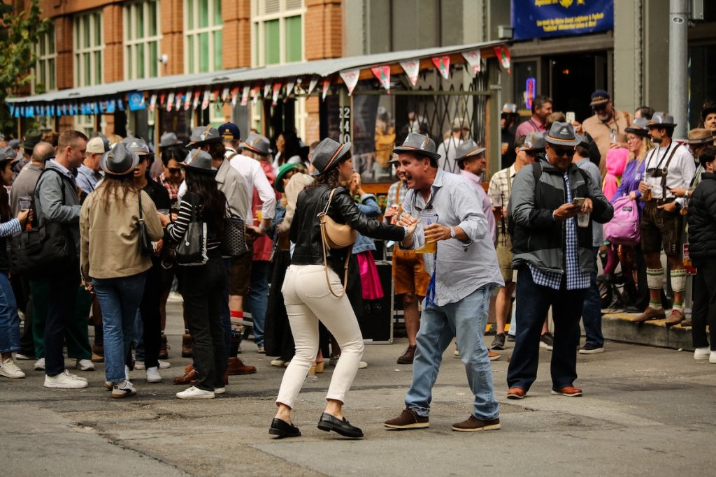 People dancing on street during Oktoberfest festival in San Francisco, California.