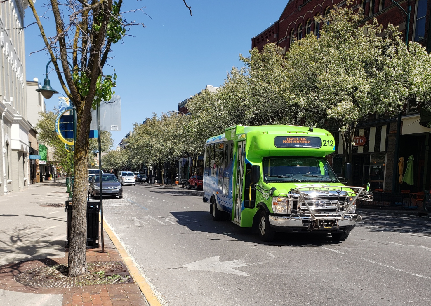 Green mini bus on street.
