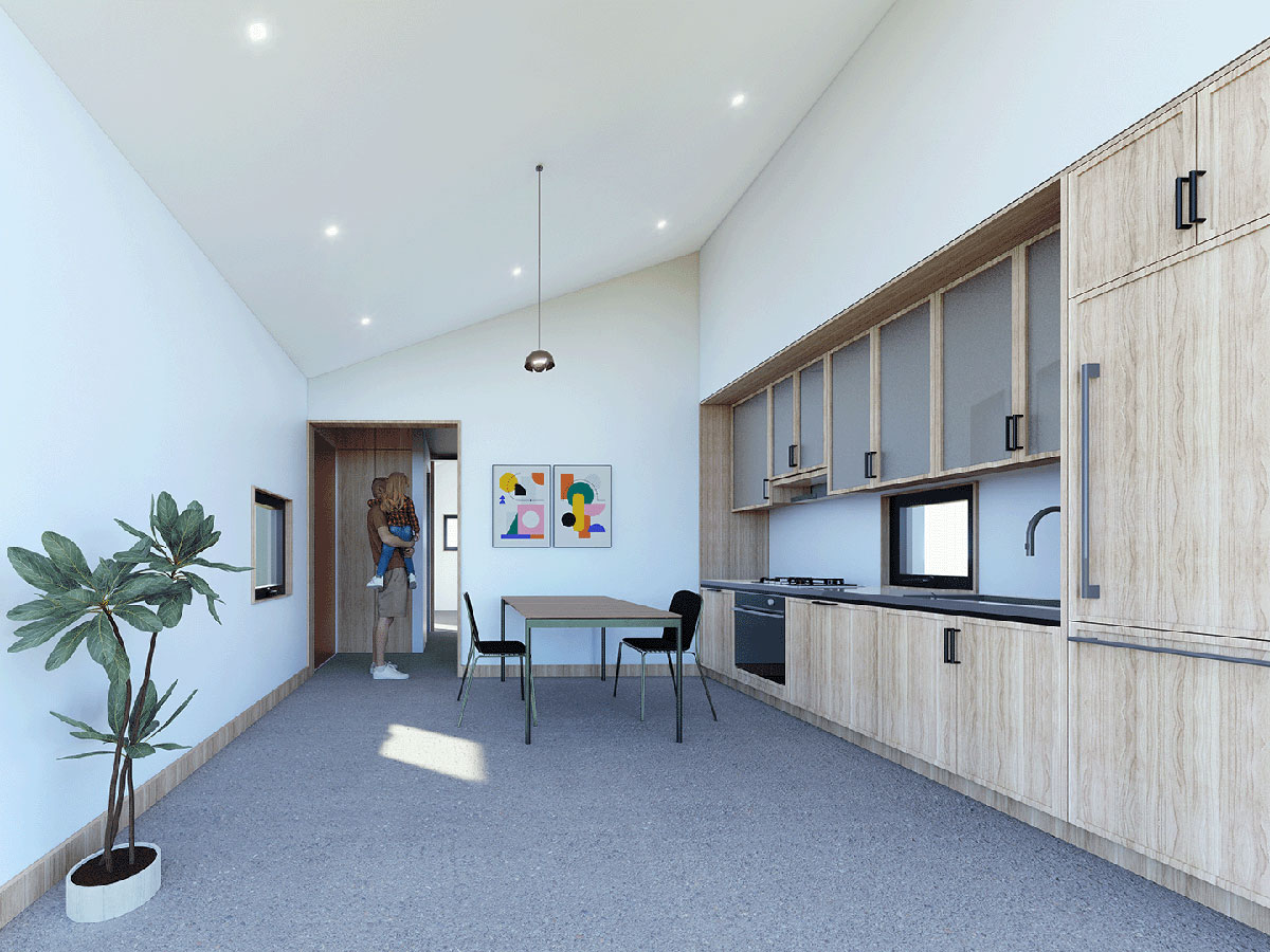 The interior of an ADU. A kitchen, small dining table and a father holding his daughter are shown.