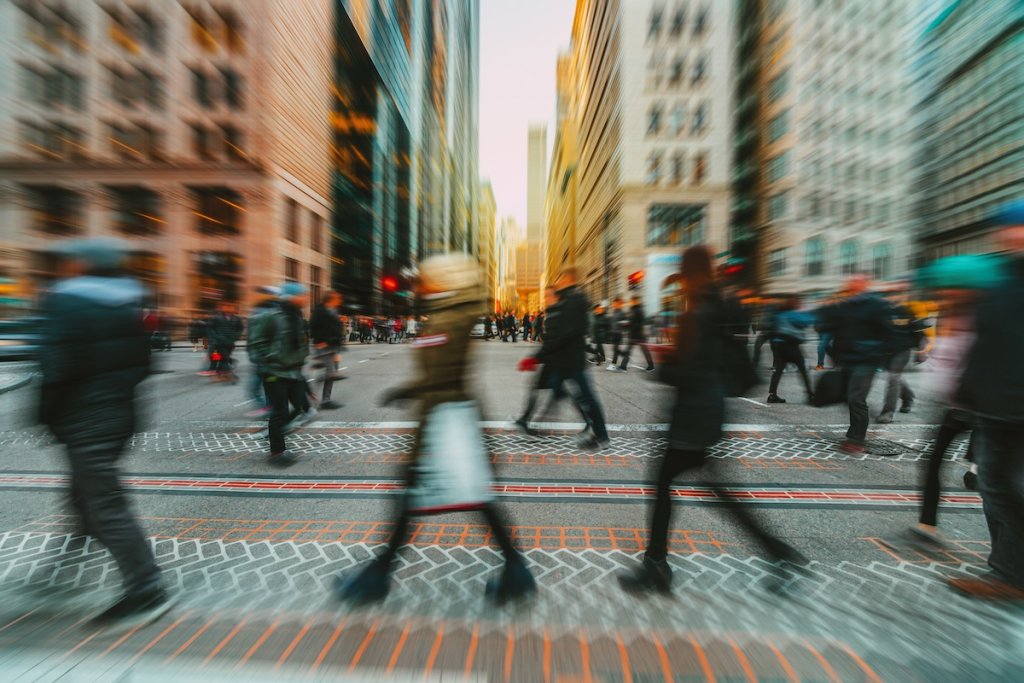 Blurred image of crowd on crosswalk in Boston, Massachusetts.