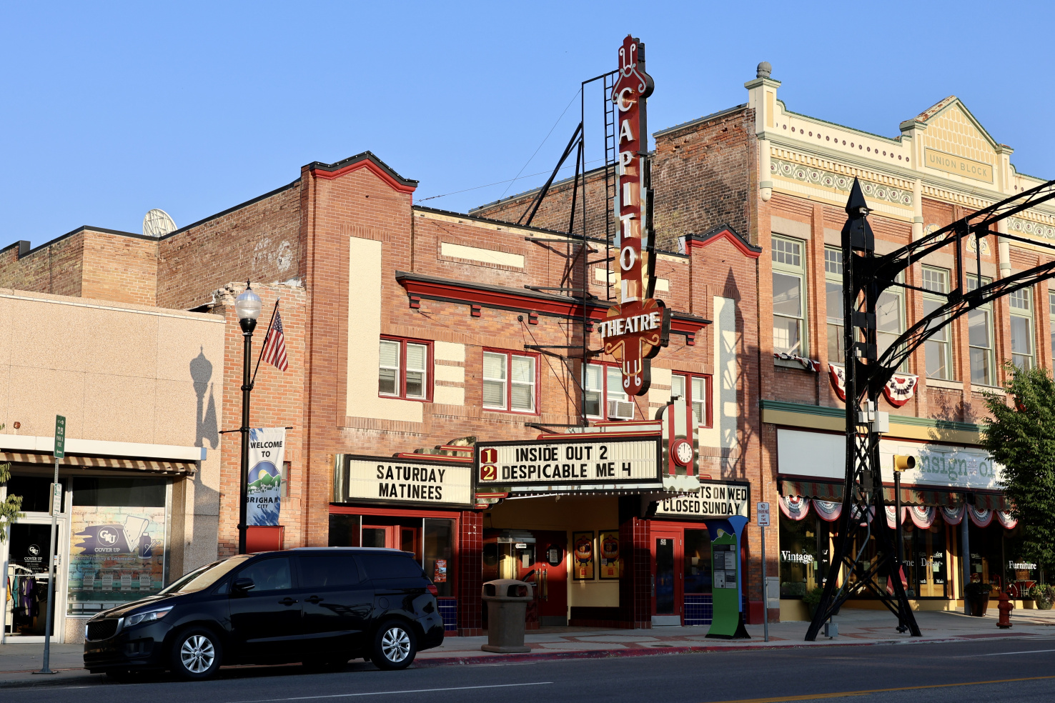 A theater with brick walls, showing Inside Out 2 and Despicable Me 4