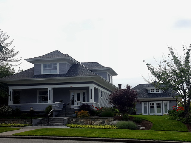 Craftsman home with matching backyard cottage next to it.