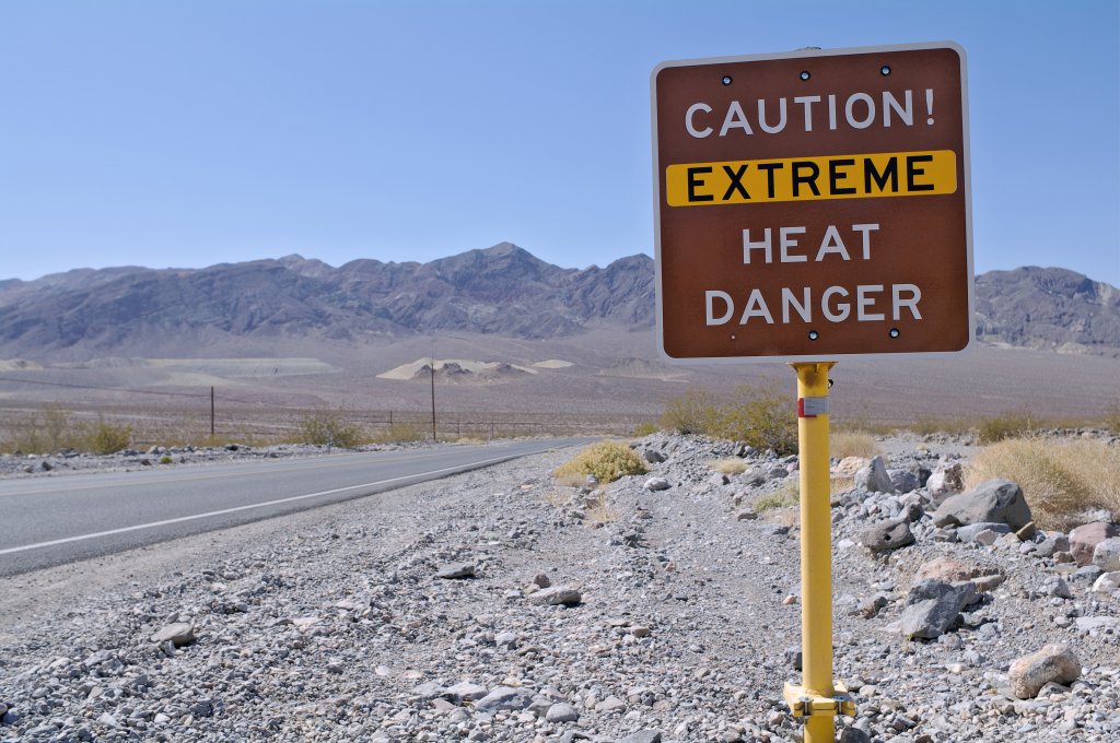 Death Valley road sign reading "Caution, Extreme Heat Danger."