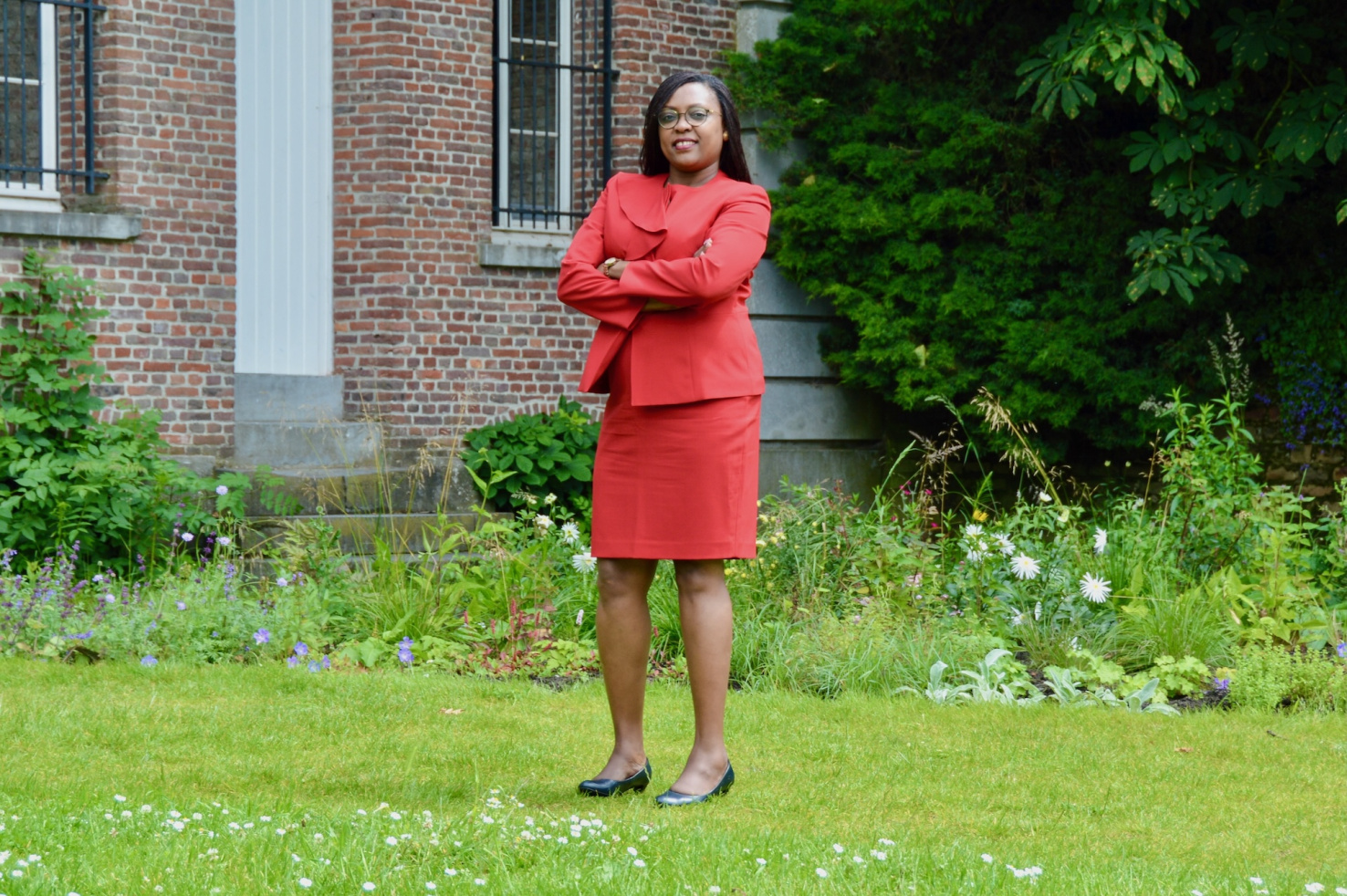 Amanda Ngabirano, KAMPALA, UGANDA wearing red suit.