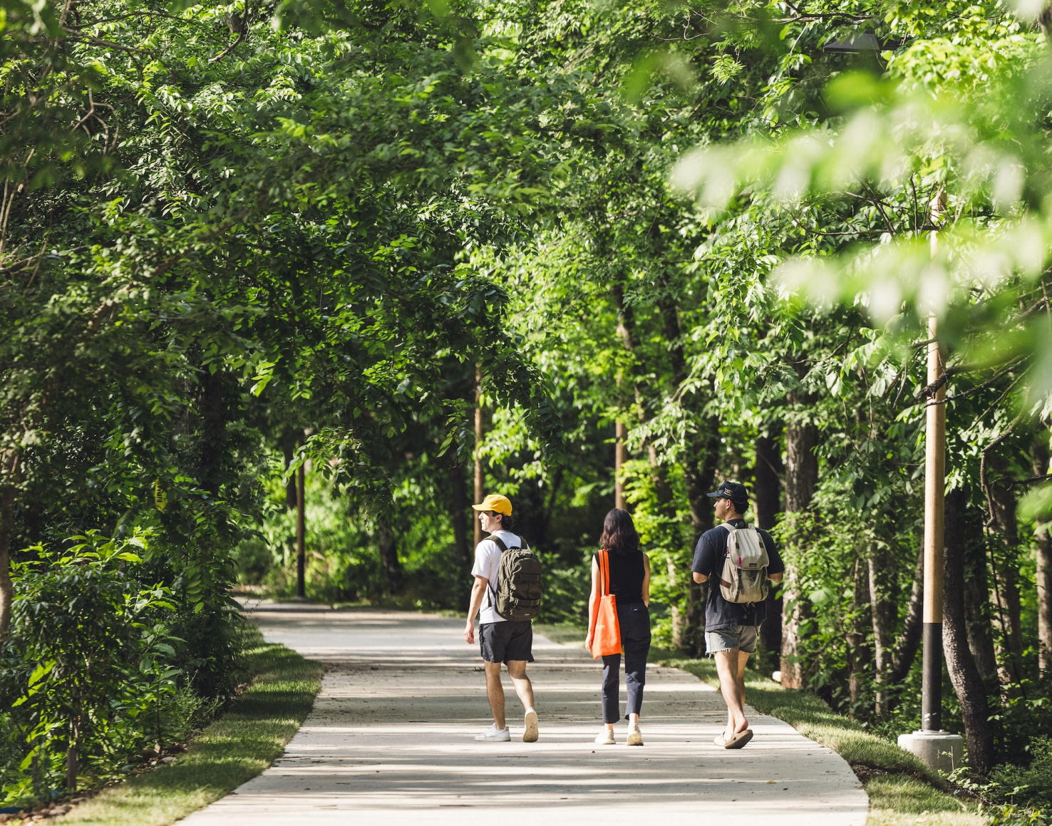 Three people walking on Razorback Greenway in Northwest Arkansas.