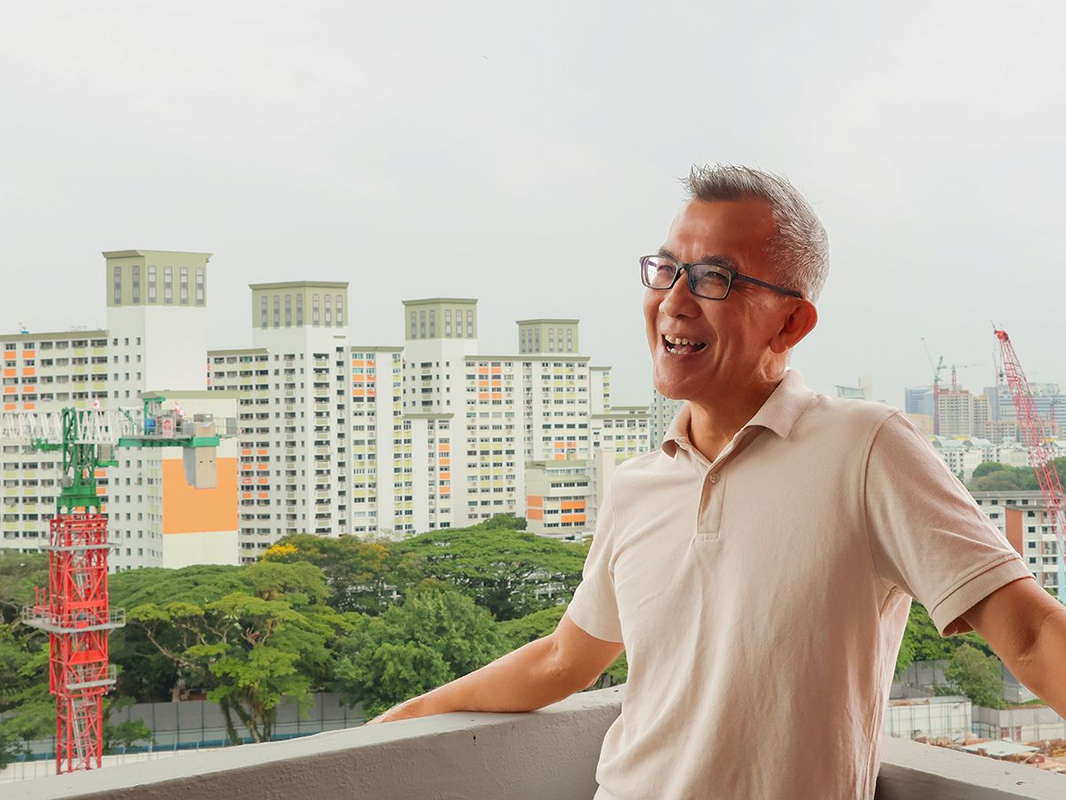 A smiling, older man from Singapore.