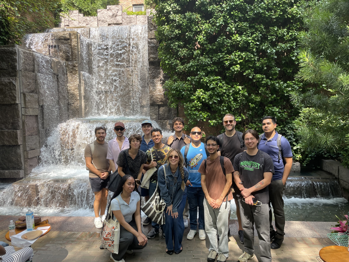 Image of students standing in front of a waterfall together smiling