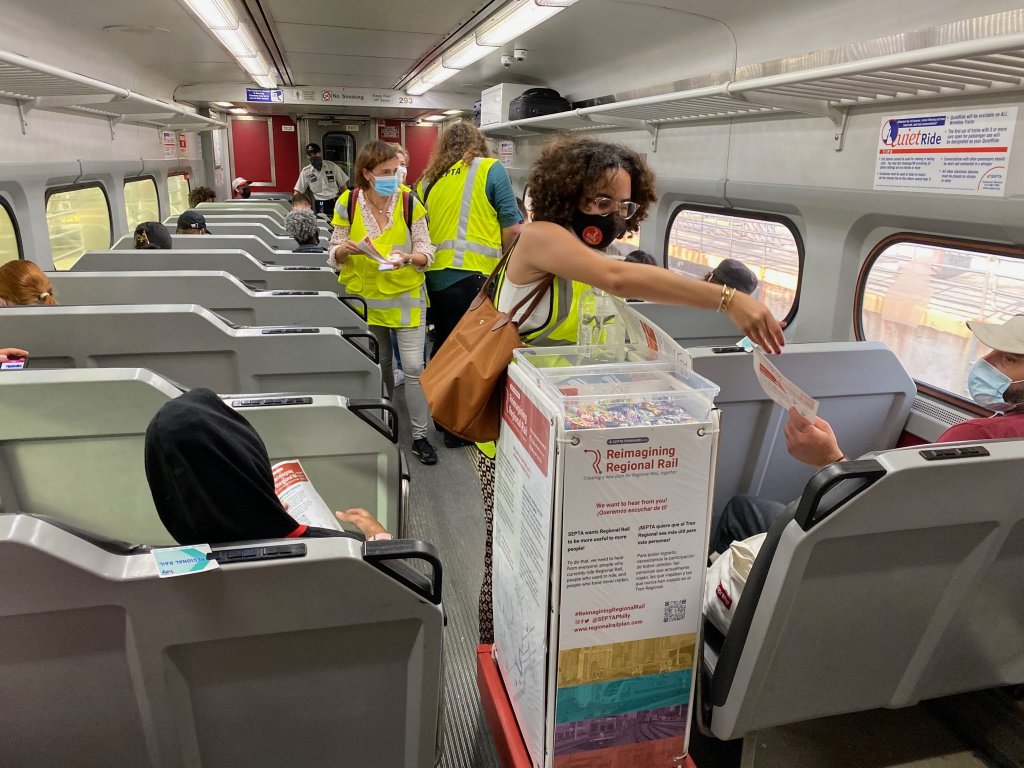 Planners wearing masks canvas a SEPTA train for information about the future of the syste,