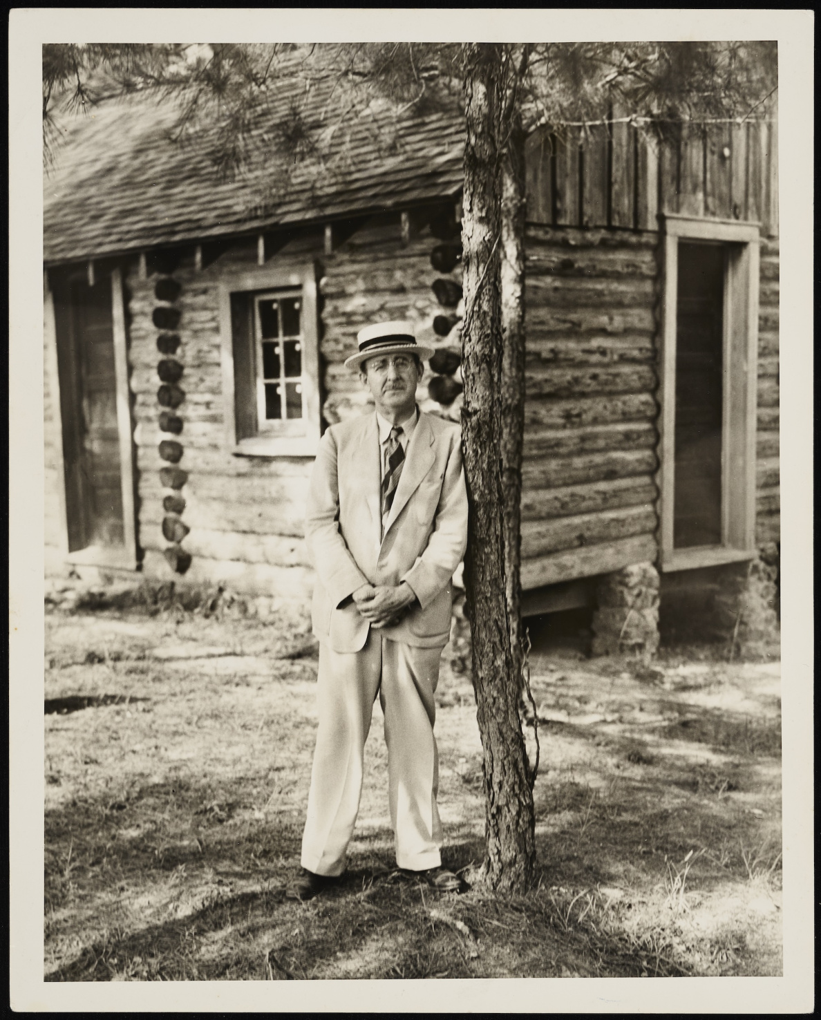 Howard Odum in front of a reconstructed cabin on his farm.