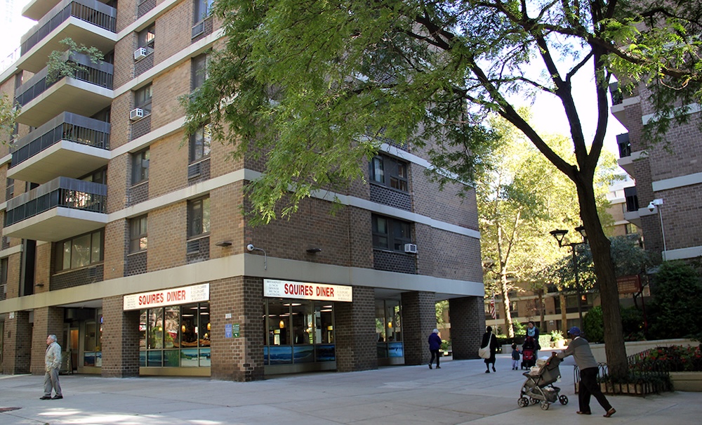 People walking in courtyard in Southbridge housing complex, Manhattan.