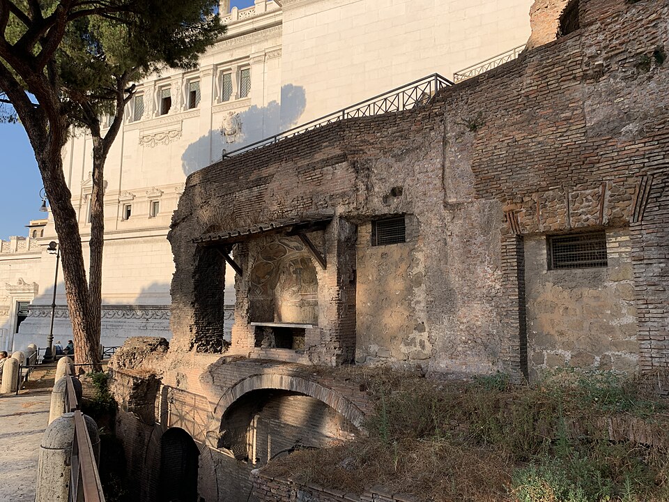 The remains of a Roman insulae, made of brown bricks and containing small windows.