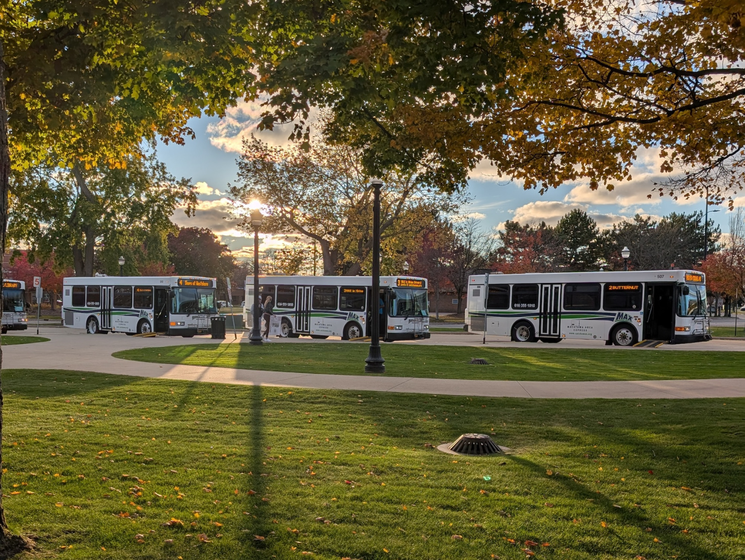 Three white transit buses operated in Holland, MI.