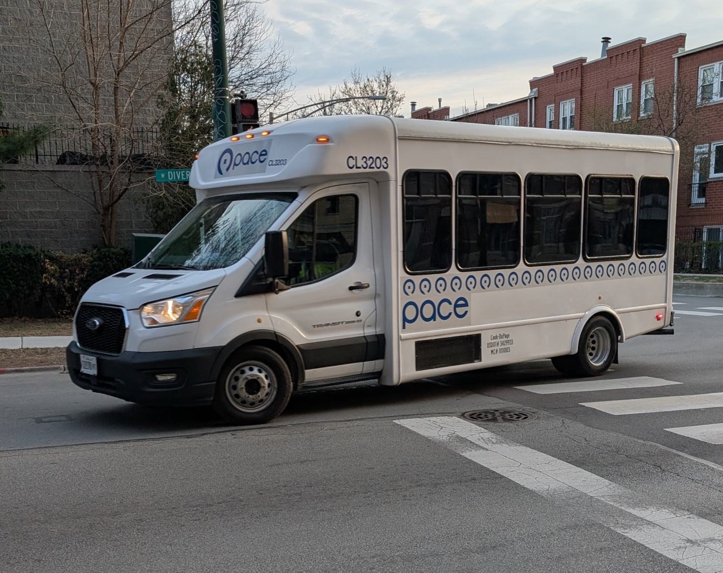 Another paratransit bus driving over a crosswalk.
