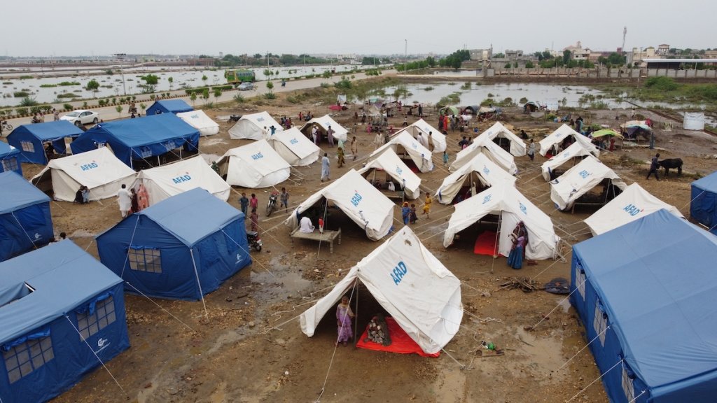 A camp full of tents , shown in Pakistan to help people displaced by flooding in 2022.