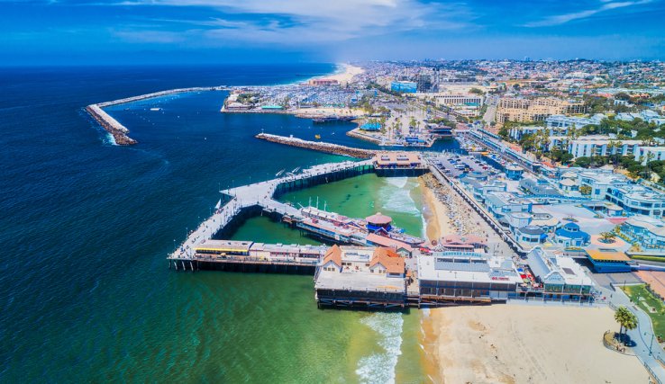 The shoreline of the Pacific Ocean, with pier and green water, in Redondo Beach, Caifornia.