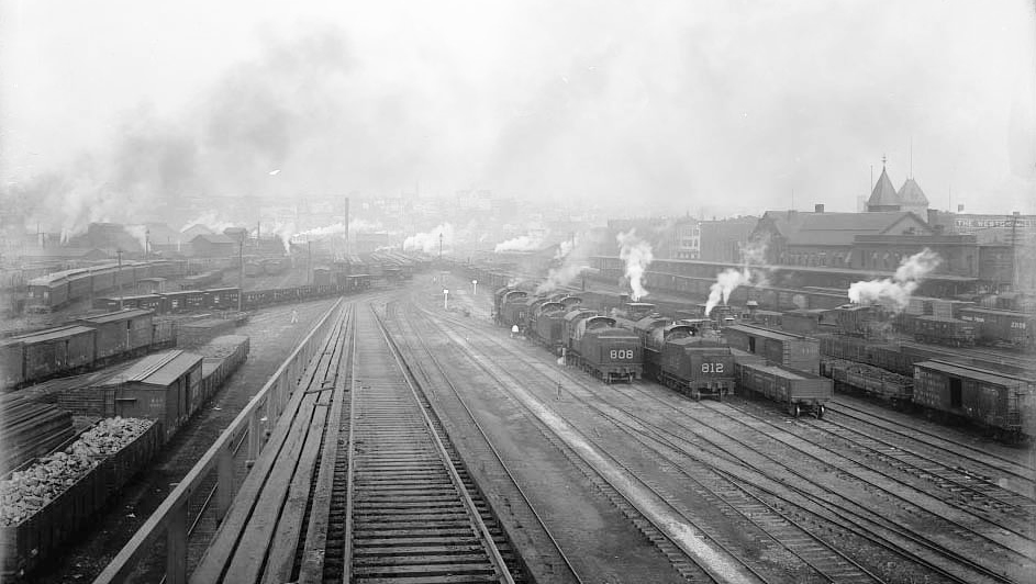A historic image of Scranton railroads, with steam or smoke rising from the engines of numerous trains, pictured in 1895.