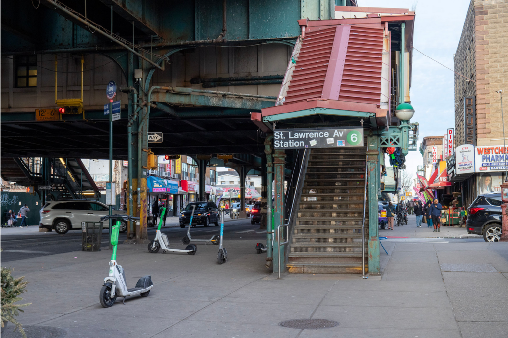 Scooters at an elevated rail station.