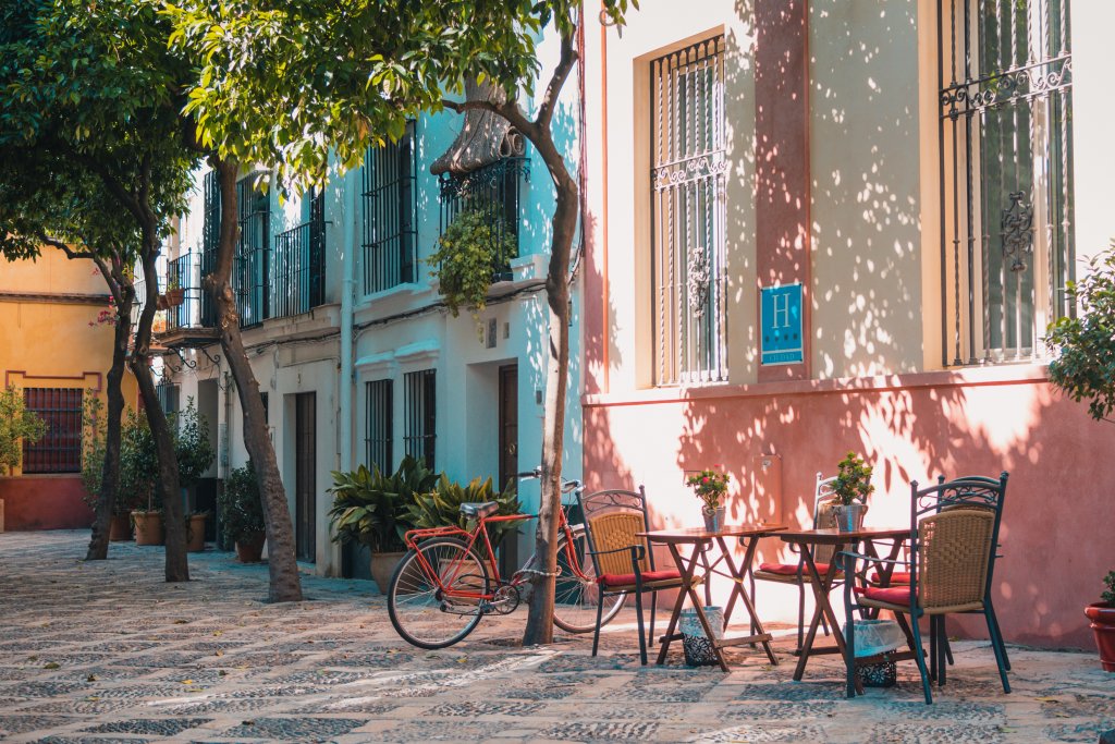 A European plaza, where cafe tables and bikes wait for humans.