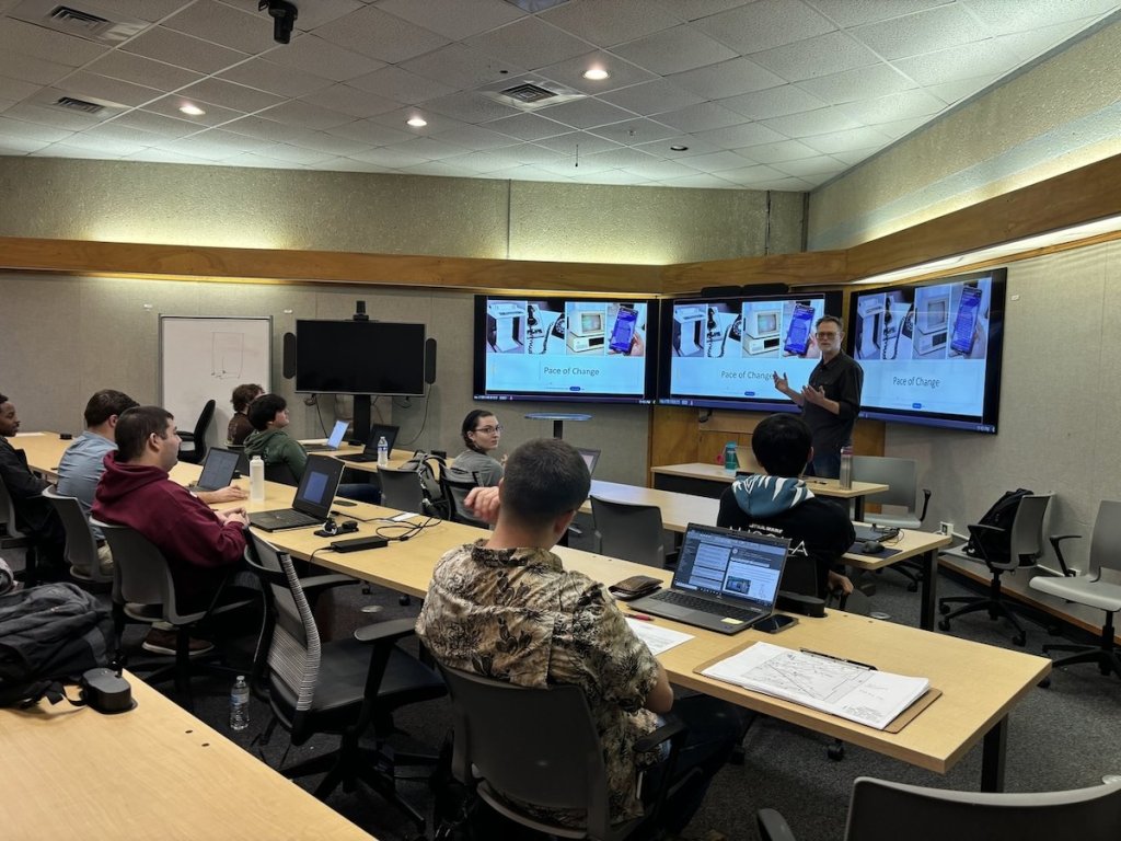 Tom delivers a lecture on AI and planning to his students at Texas A&M University.