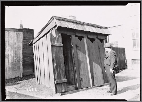 Tenement officer inspecting outhouses