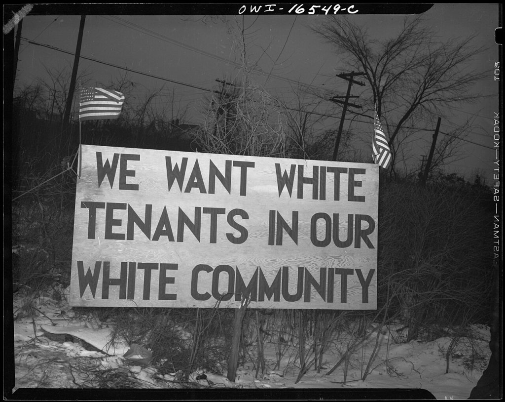 Sign with American flag "We want white tenants in our white community," directly opposite the Sojourner Truth homes, a new U.S. federal housing project in Detroit, Michigan. A riot was caused by white neighbors' attempts to prevent Negro tenants from moving in.