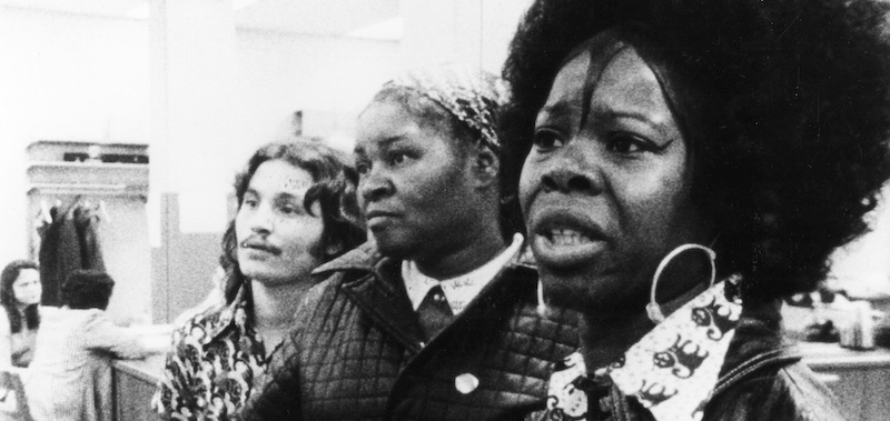 B&W image of people in 1970s welfare office.