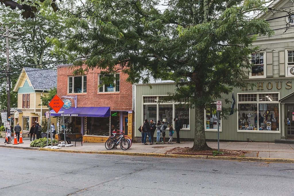 People stand on sidewalk in Woodstock, NY