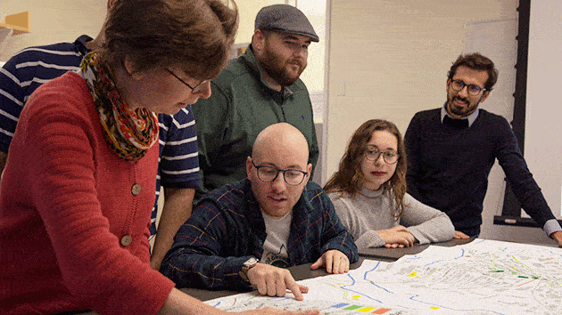Image of people disccusing a topic around a table