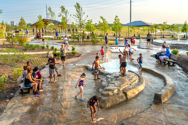 Children playing in water play area.