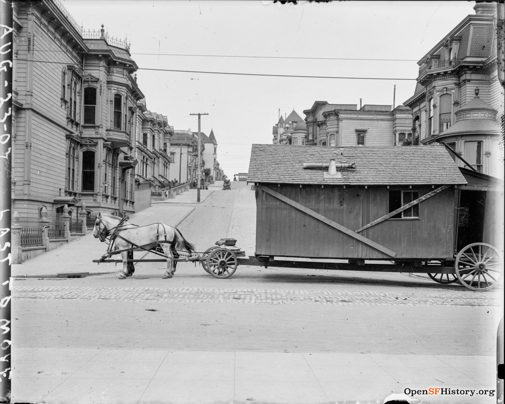 Horse team moving a 1906 Earthquake refugee cottage from Jefferson Square, San Francisco CA.