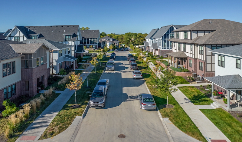 Photo of a housing- and car lined street in Prairie Queen Missing Middle Neighborhood in Papillion, NE.