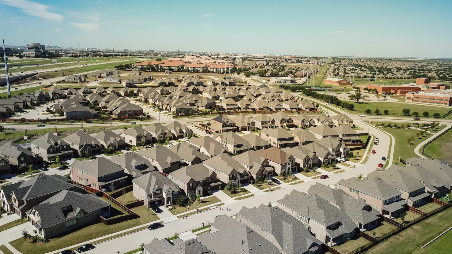 Aerial view new residential neighborhood situated between highway and school district near Dallas, Texas, USA. 