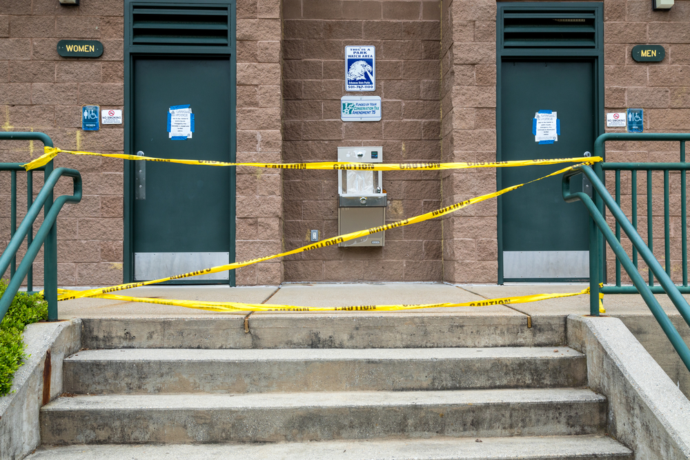 Closed public park bothrooms with yellow caution tape