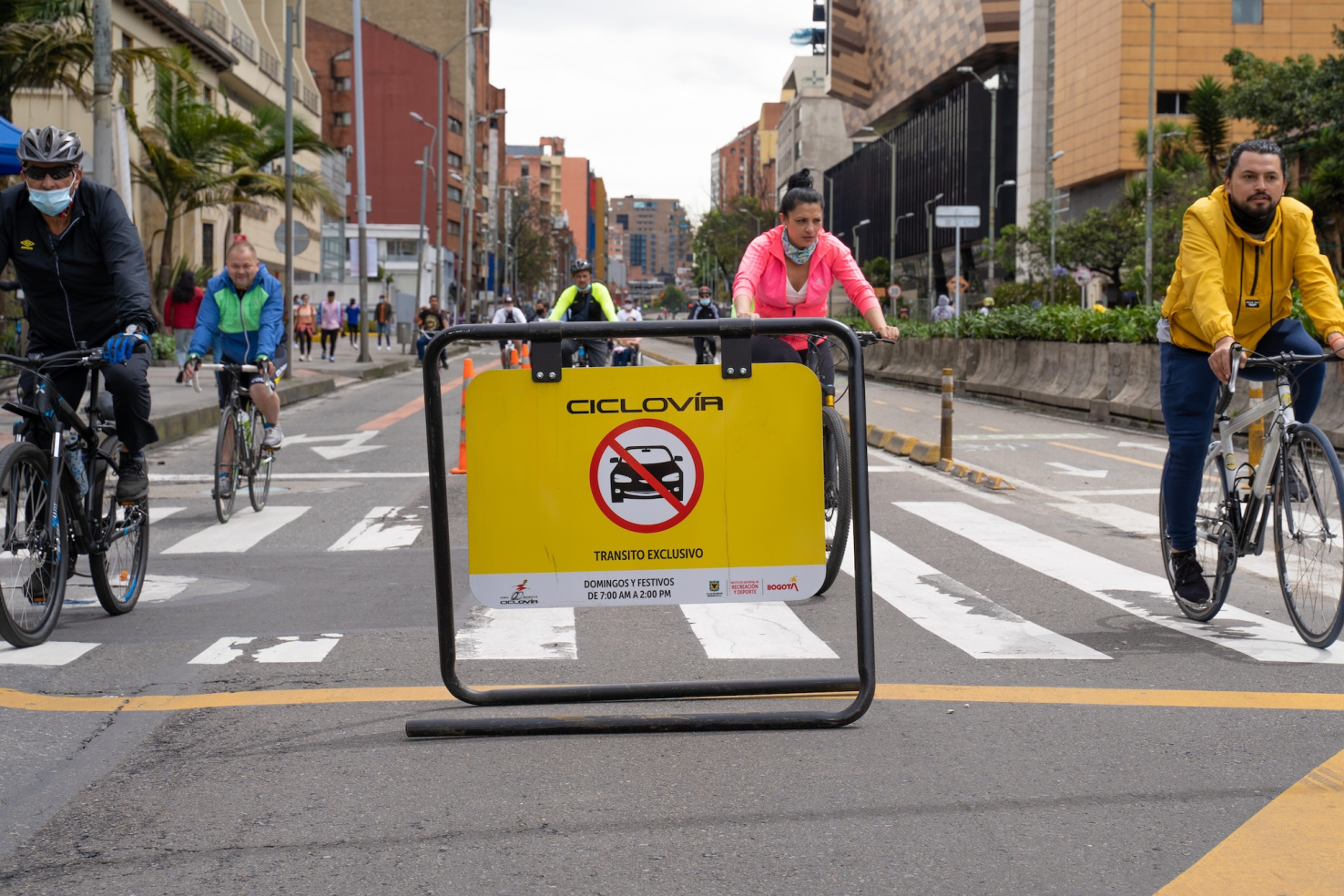 Peope riding bikes during Ciclovia on street in Bogota, Colombia.