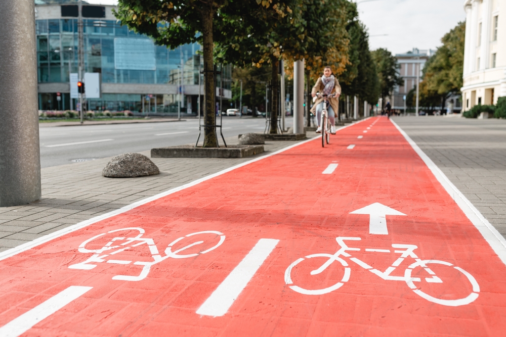 Red painted bike path on urban walkway