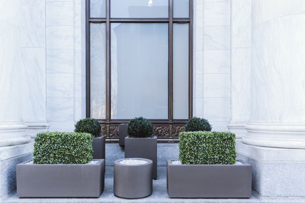 Planters on sidewalk to prevent sleeping in building alcove