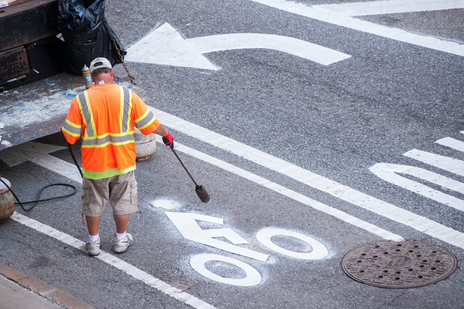 Contractors working for the NY Department of Transportation install new thermoplastic bike lane markings on the bicycle lane pavement