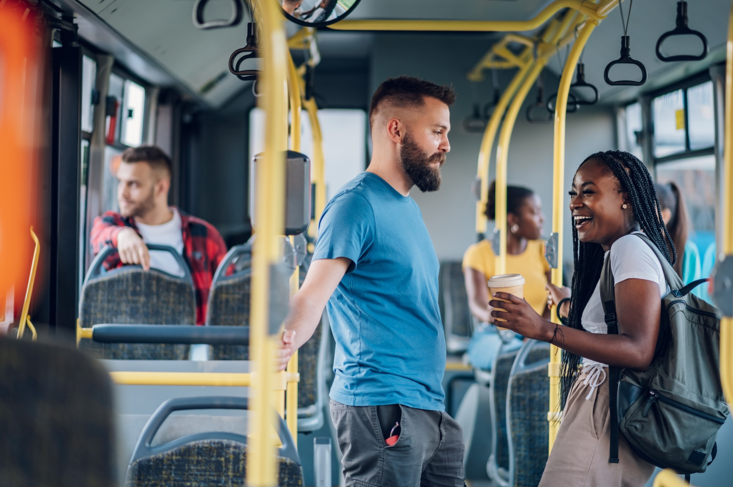 Diverse group of young people on a city bus.