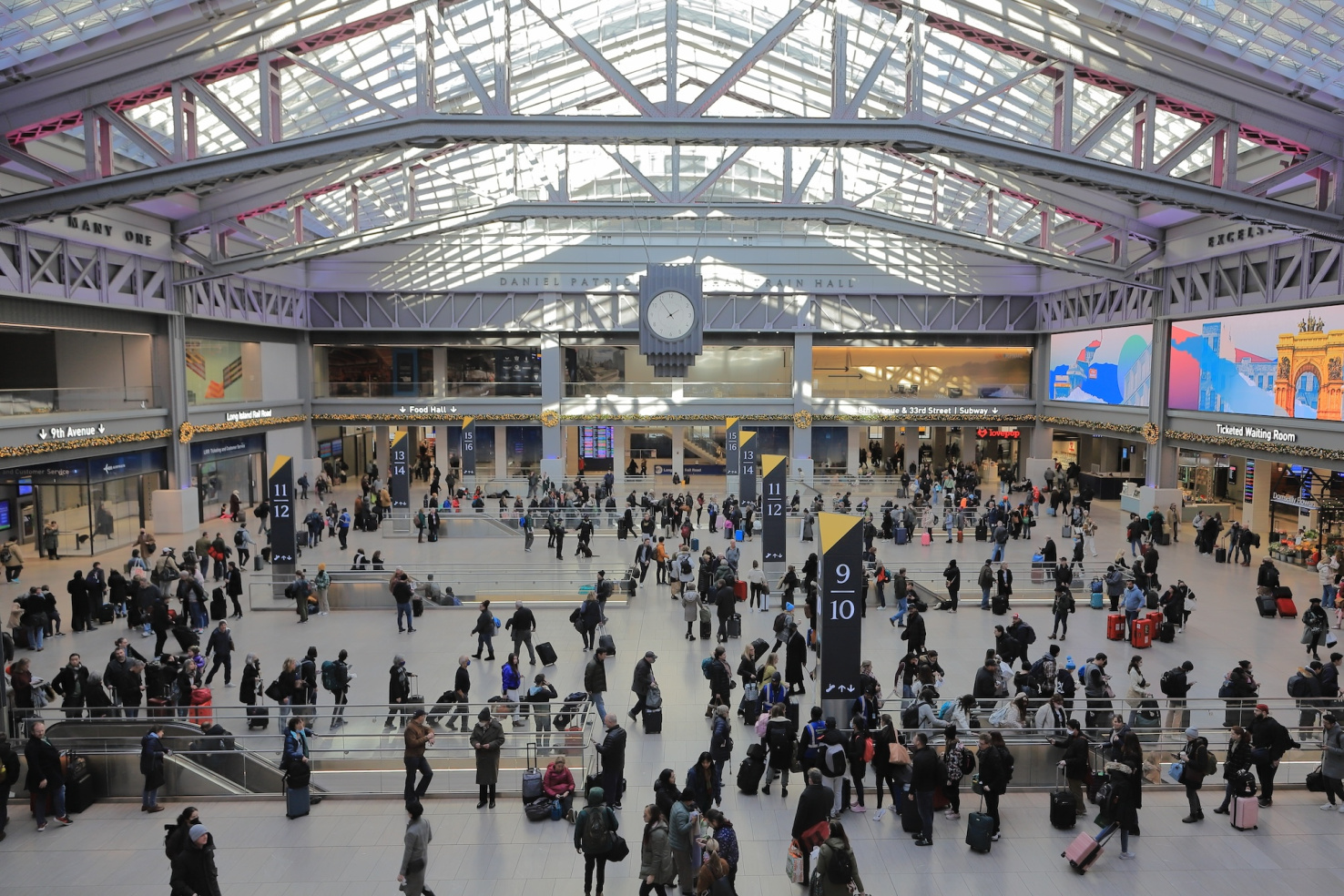 Looking down on crowds in NYC Moynihan train hall.