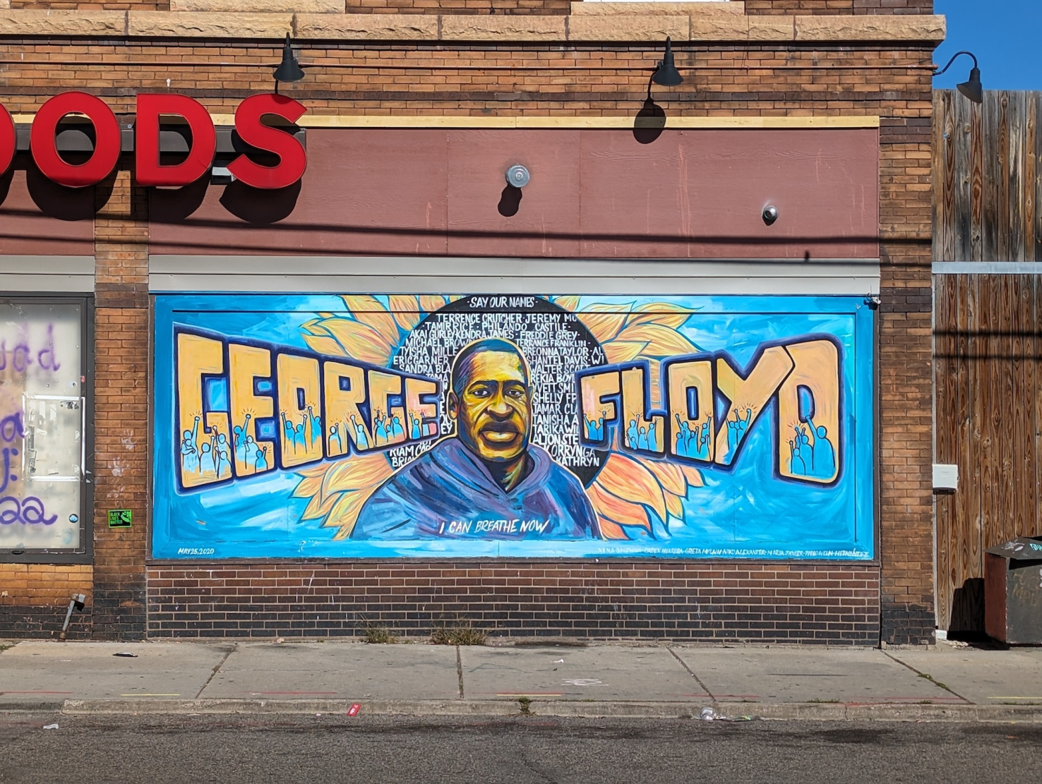 George Floyd memorial mural on brick wall.