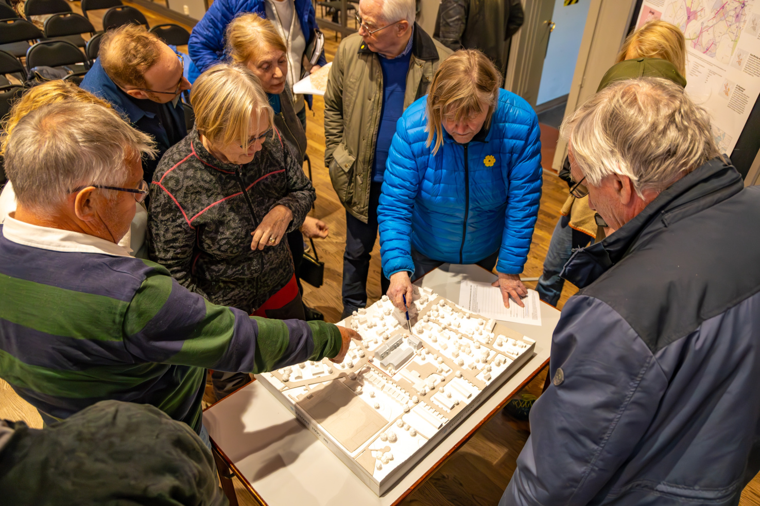 People gather around a table at a public consultation
