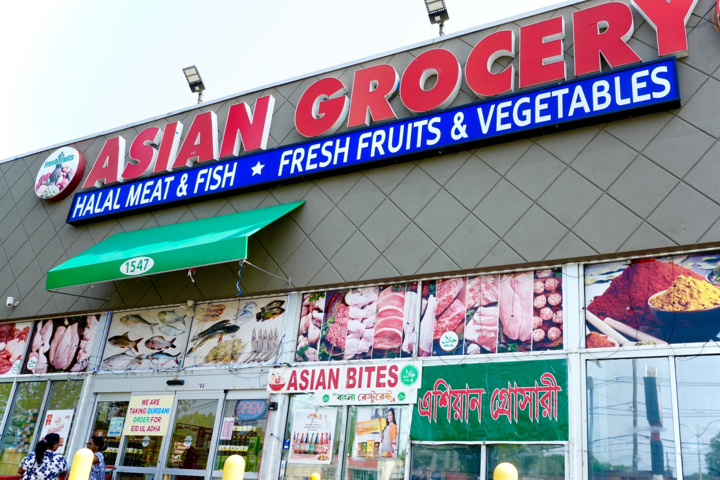 Asian grocerty store with photos of merchandise in window.