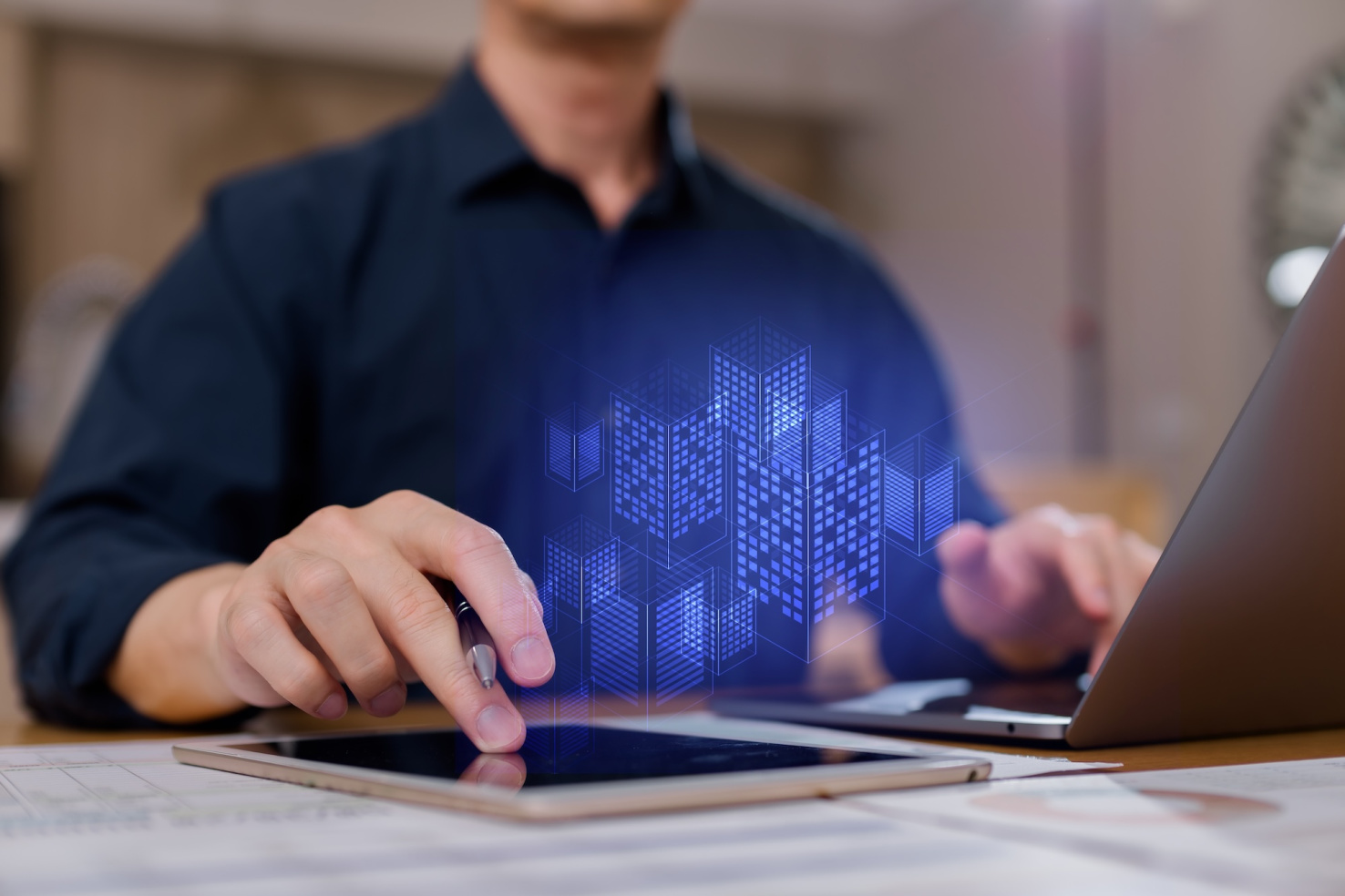 Businessman using digital tablet with 3D smart city hologram, concept of real estate technology, digital transformation, architecture urban planning innovation.