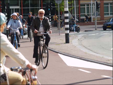a bicyclist on a cobblestone street.